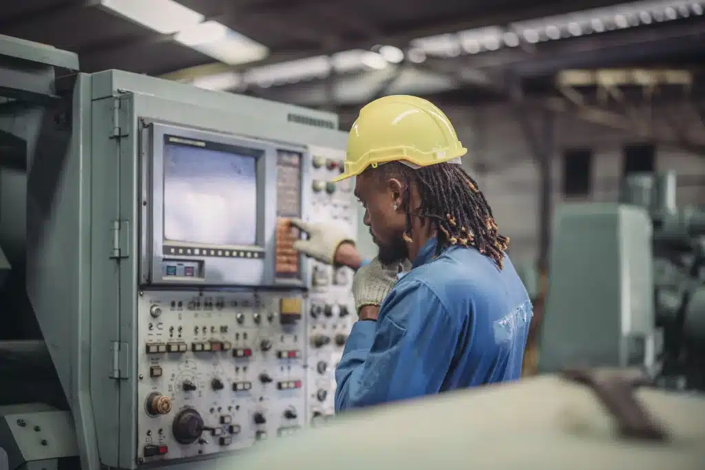 Technician adjusting manufacturing machine in the factory